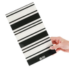 Hand holding the Retro Stripe balayage board in bold black and white stripes