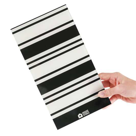 Hand holding the Retro Stripe balayage board in bold black and white stripes