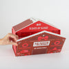 Hand holding the closed 10 Days of Sleigh gingerbread house advent calendar box