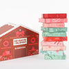 10 Days of Sleigh gingerbread house advent calendar beside a stack of ten numbered mystery foil boxes