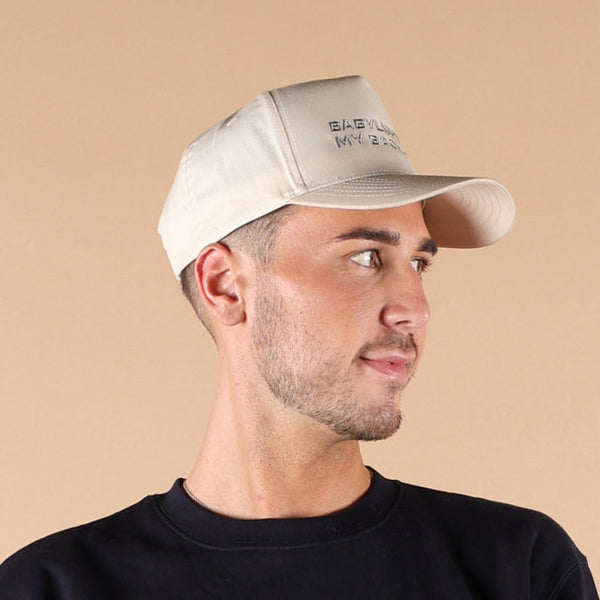 Tan beige Babylighting My Back Out Hat worn by hair stylist in salon