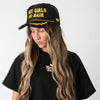 Model in a black tee wearing the black Hot Girls Do Hair hat