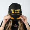 Model wearing the black Hot Girls Do Hair trucker hat with yellow puff embroidery