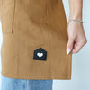 HOF Everyday Apron in brown worn by hair stylist in salon
