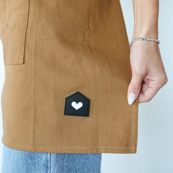 HOF Everyday Apron in brown worn by hair stylist in salon
