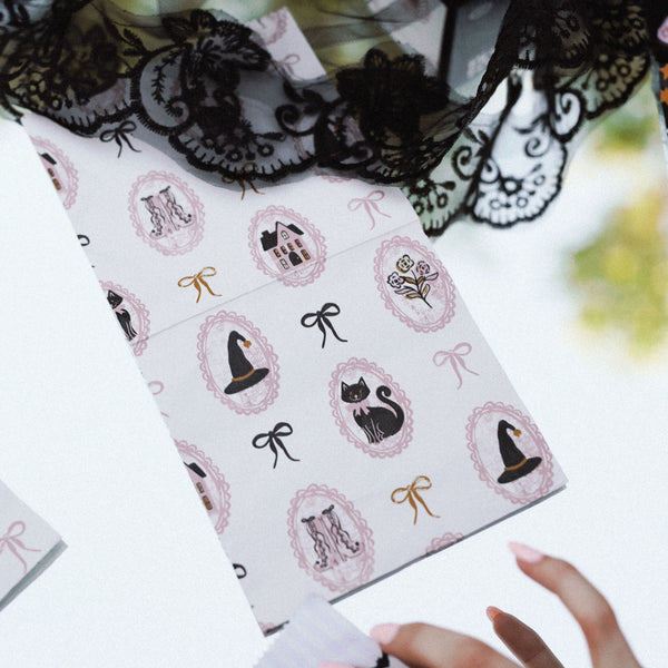 Hand holding open a box of Haunted Mansion Halloween print hair foil