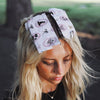 Model wearing Haunted Mansion printed foil sheets in her blonde hair outdoors
