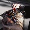 Stylist applying House of Monster Mash foil to a blonde client's hair
