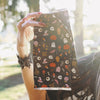 Folded House of Monster Mash foil sheets held up showing the black Halloween icon print