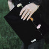 Hand resting on the black Midnight Balayage Board with a balayage brush