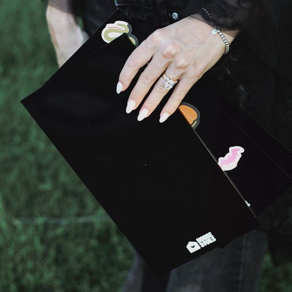 Hand resting on the black Midnight Balayage Board with a balayage brush