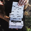 Hand pulling House of Batties bat print foil sheets from the pop-up box