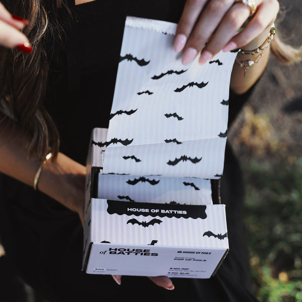 Hand pulling House of Batties bat print foil sheets from the pop-up box