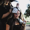 Model wearing House of Batties bat print foil sheets in her hair outdoors