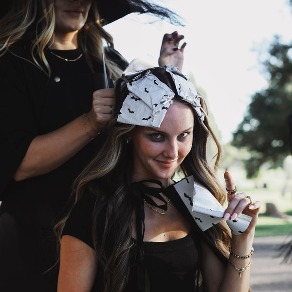 Model wearing House of Batties bat print foil sheets in her hair outdoors